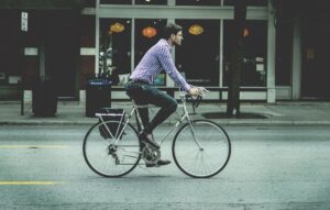 A student is going to college by bicycle.