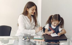 A professional teacher is teaching her students at home.